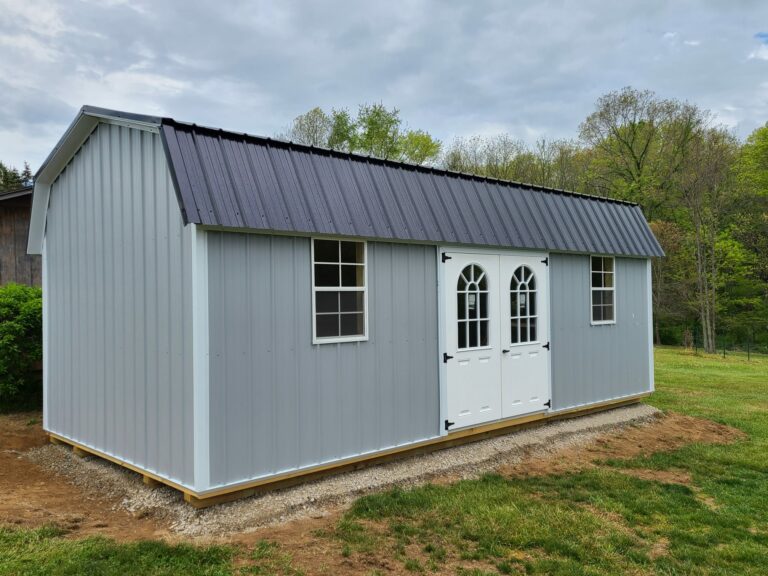 grey metal barn shed with a brown metal roof