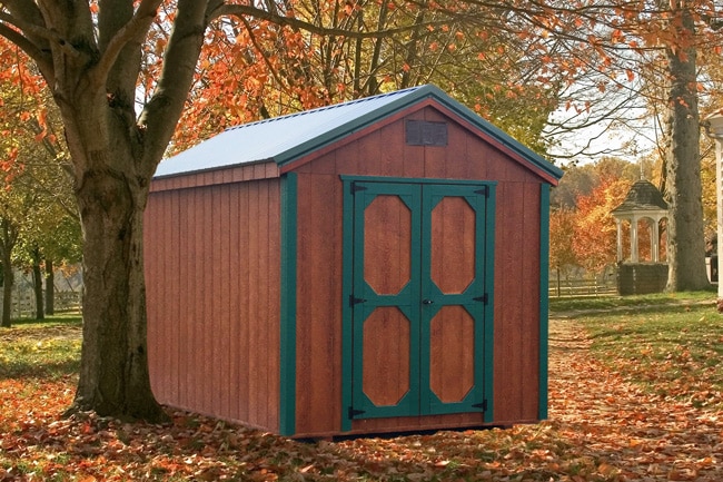 brown a frame wood shed with green metal trimming